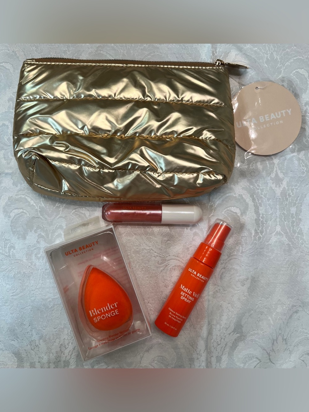 ULTA Beauty Gold Cosmetic Bag with Blender Sponge, Setting Spray & Lip Gloss
